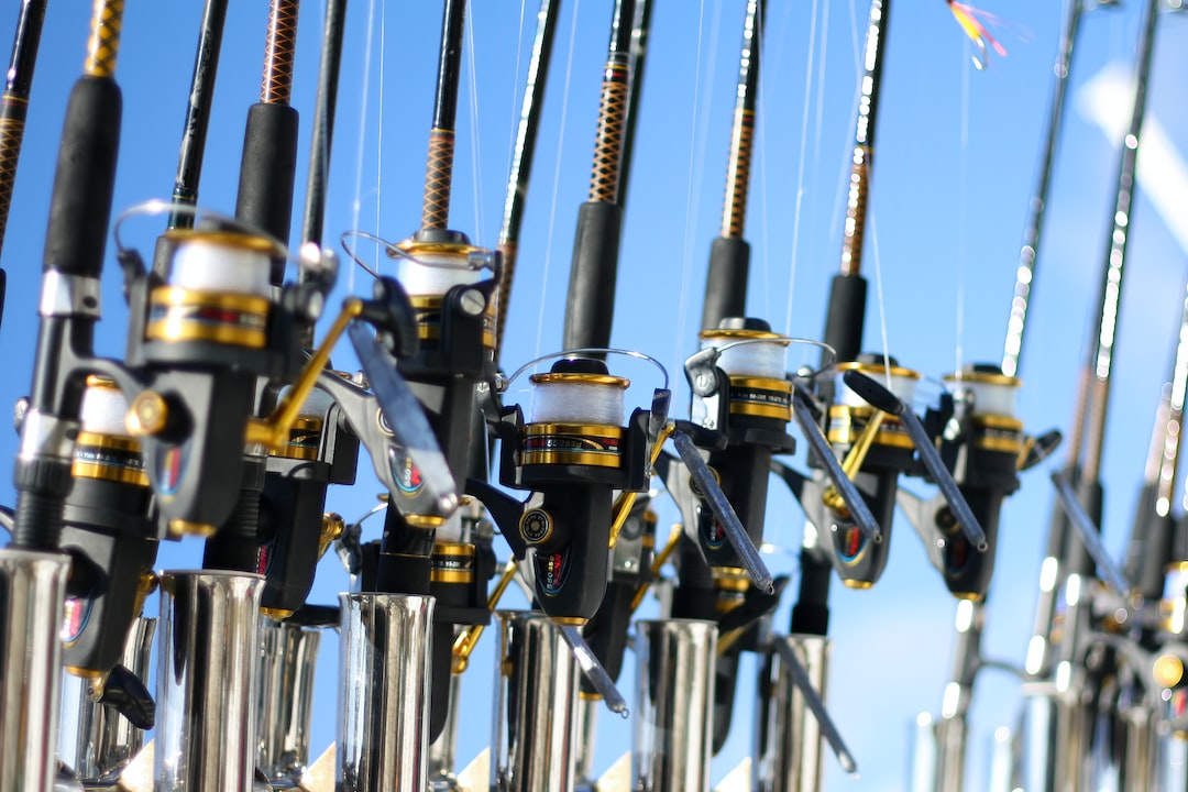 several fishing rods, reels and lines with blue skies on the background